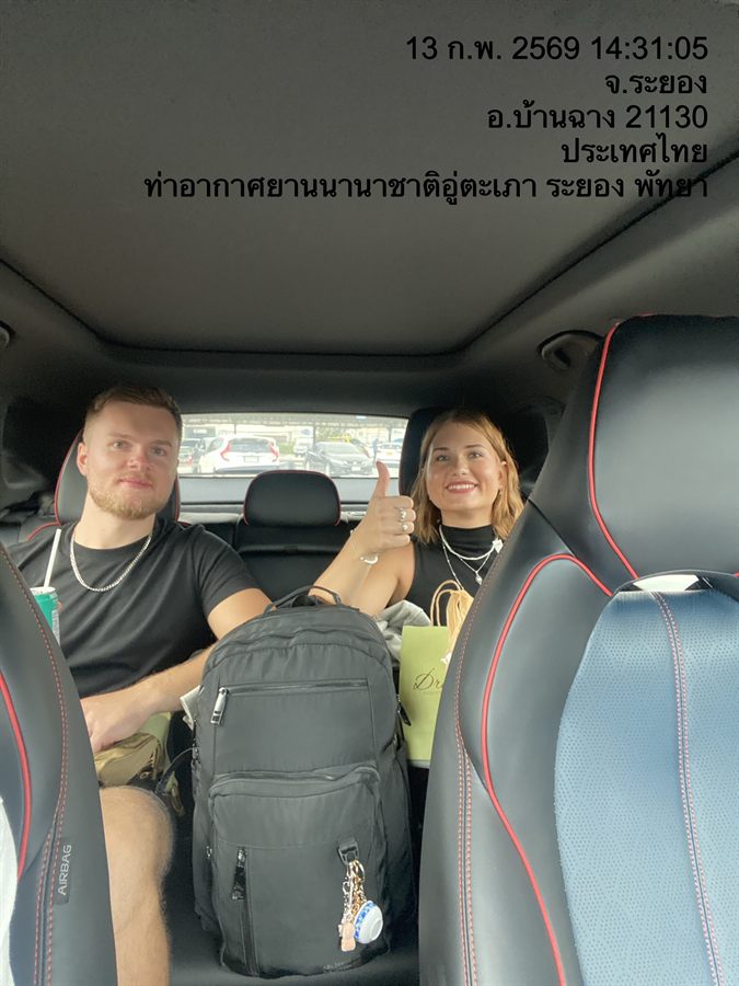 Two travellers with their luggage in a WayGo car at U-Tapao Airport, Rayong.