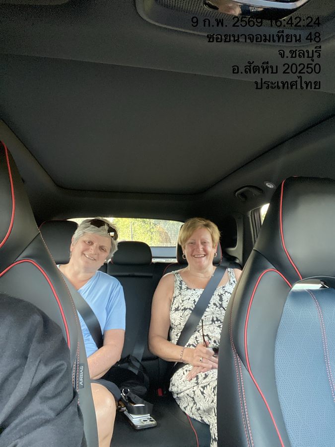 Two guests belted into the rear seats of a WayGo car at Na Jomtien, Chonburi.